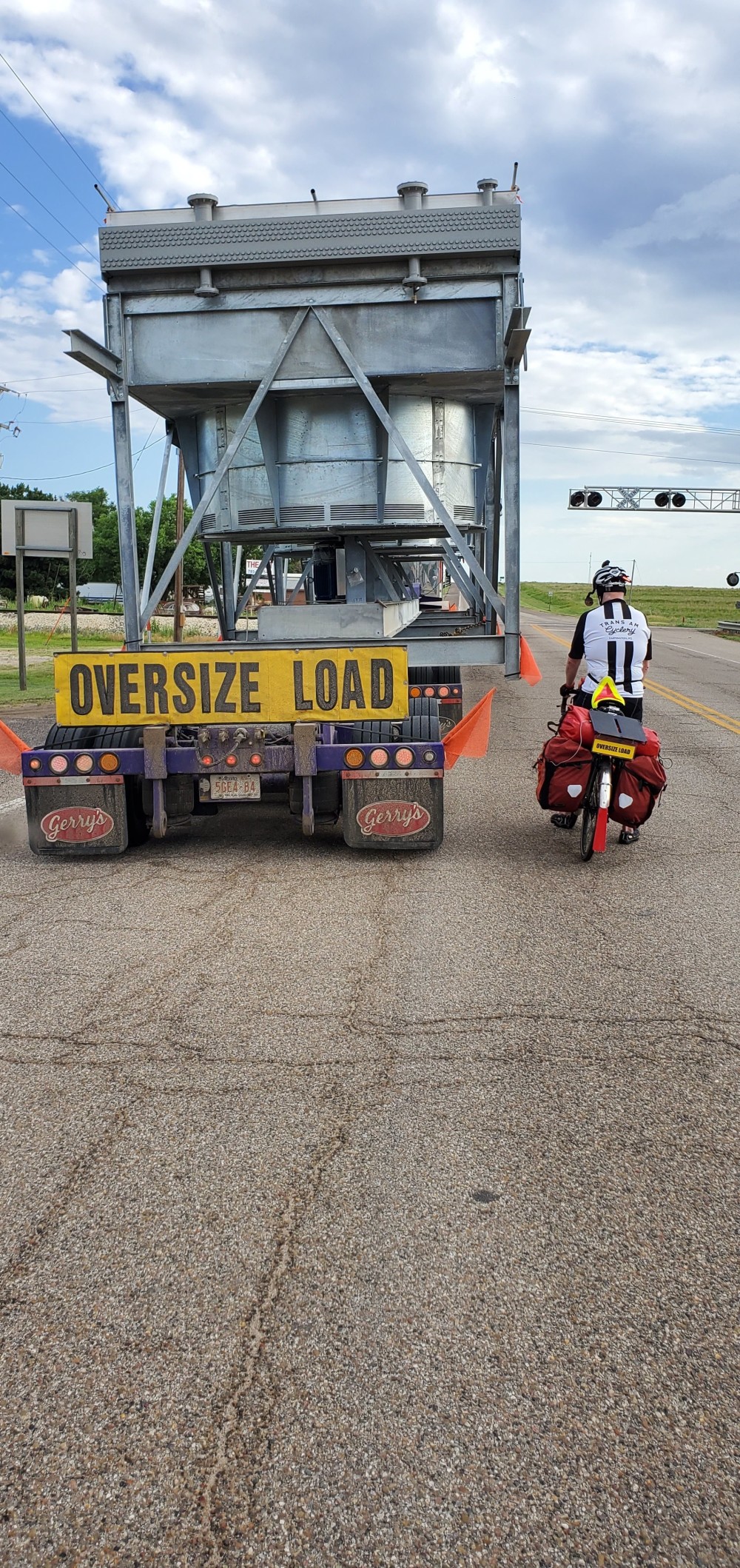 This truck was stuck, because they couldn't fit under the railroad signs. They had to get permits to use a different road, so they were directing traffic around the truck. When they saw my "OVERSIZE LOAD" sign, they wanted a picture, so I asked them to take one with my phone too!