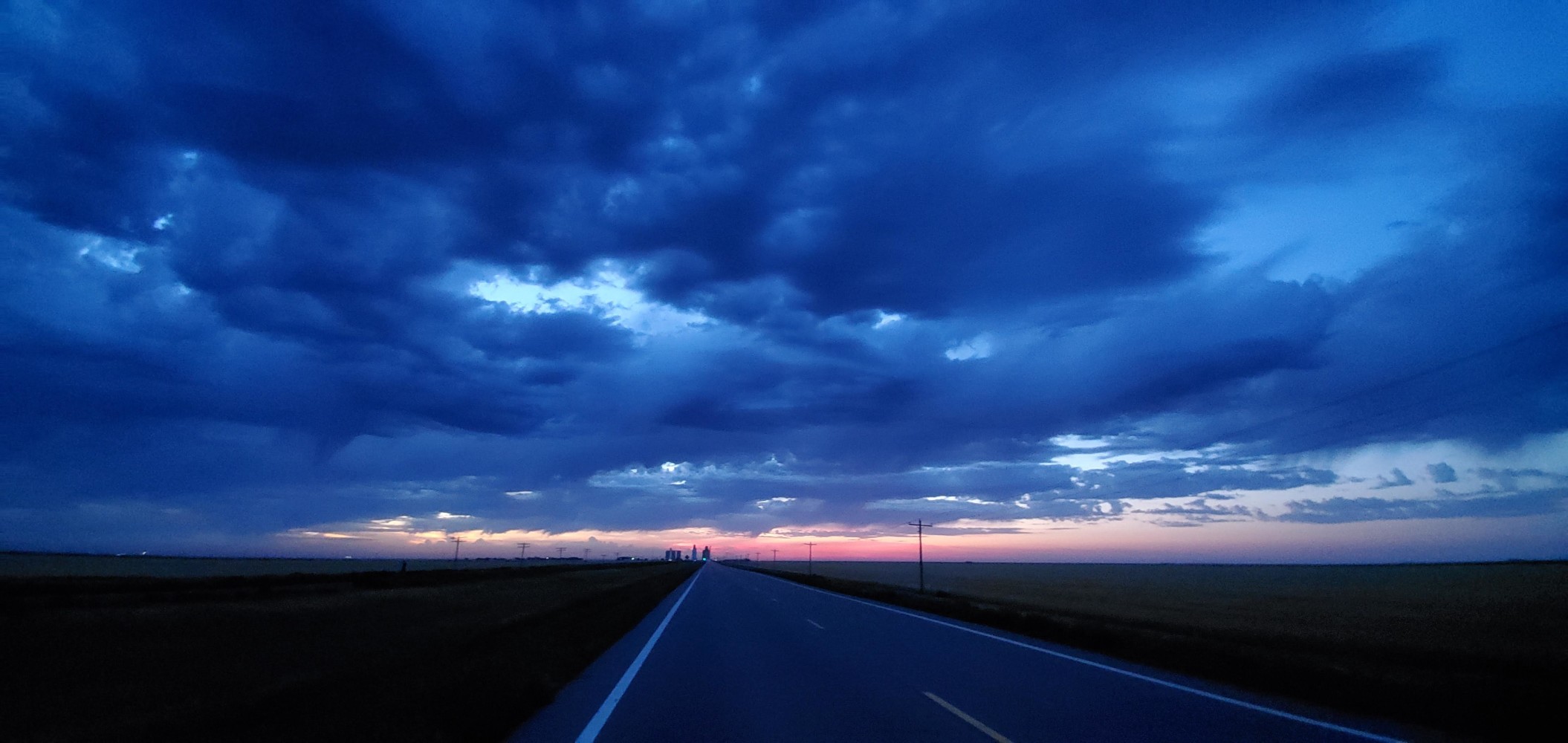 Pre-dawn. Grain elevators are the skyscrapers of the prairie. They're visible for many miles before you reach them.