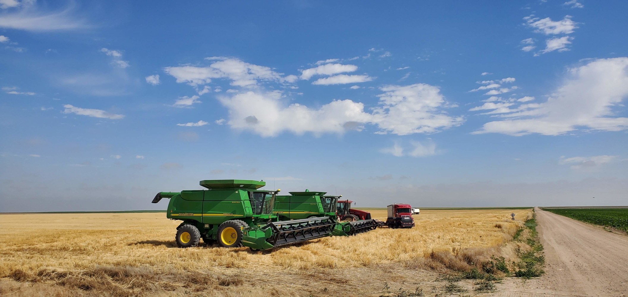 These wheat harvesters (I think they are called custom cutters) pass me on the road all the time. They travel all around the country harvesting wheat. The vehicles are twice the width of normal vehicles, so when I see them coming, I usually just get off the road and stop. If I wave, sometimes they give me a friendly honk. This crew was just getting ready to start. I really wanted to talk to one of them, but they looked busy.