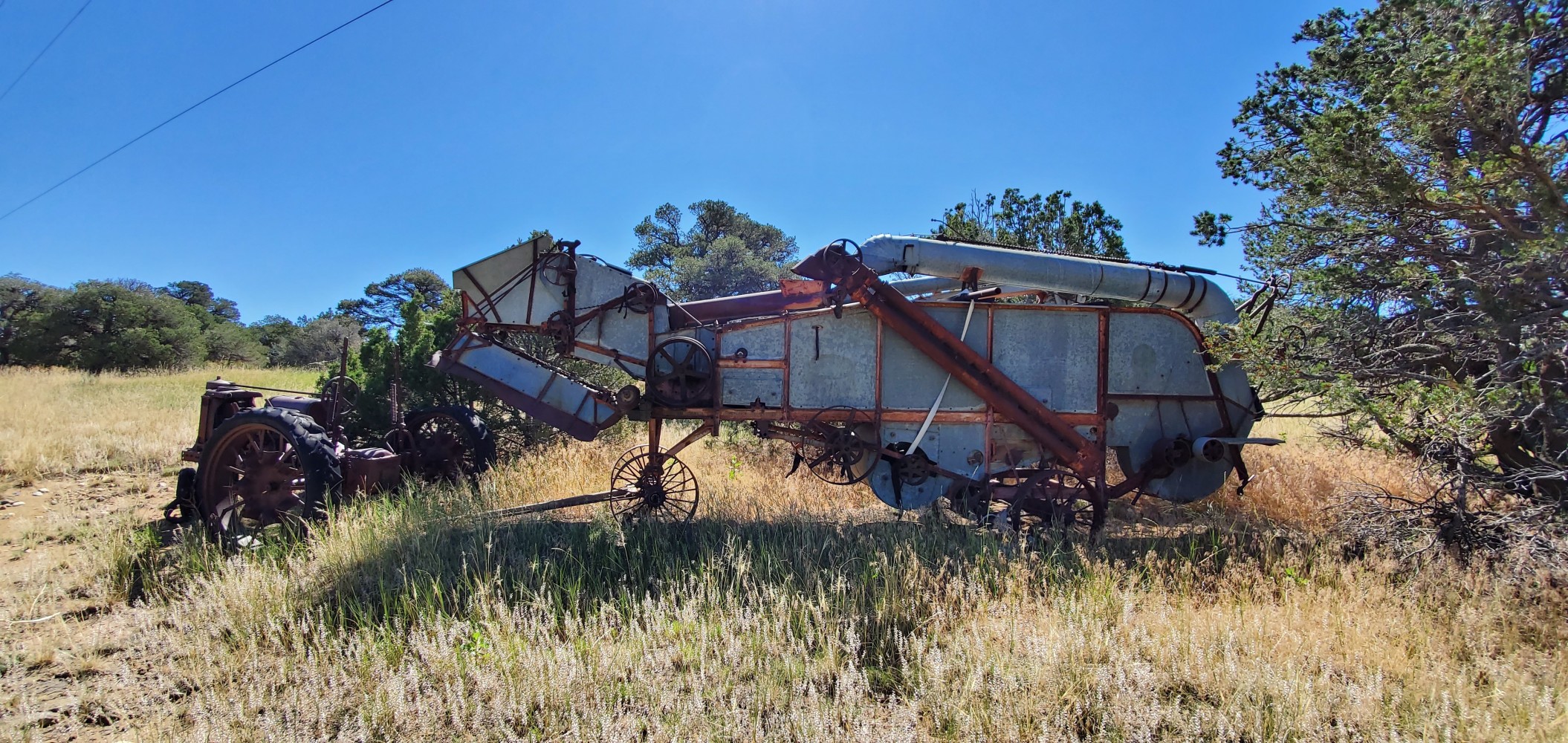 Old tractor and farm machinery. Maybe a harvester?
