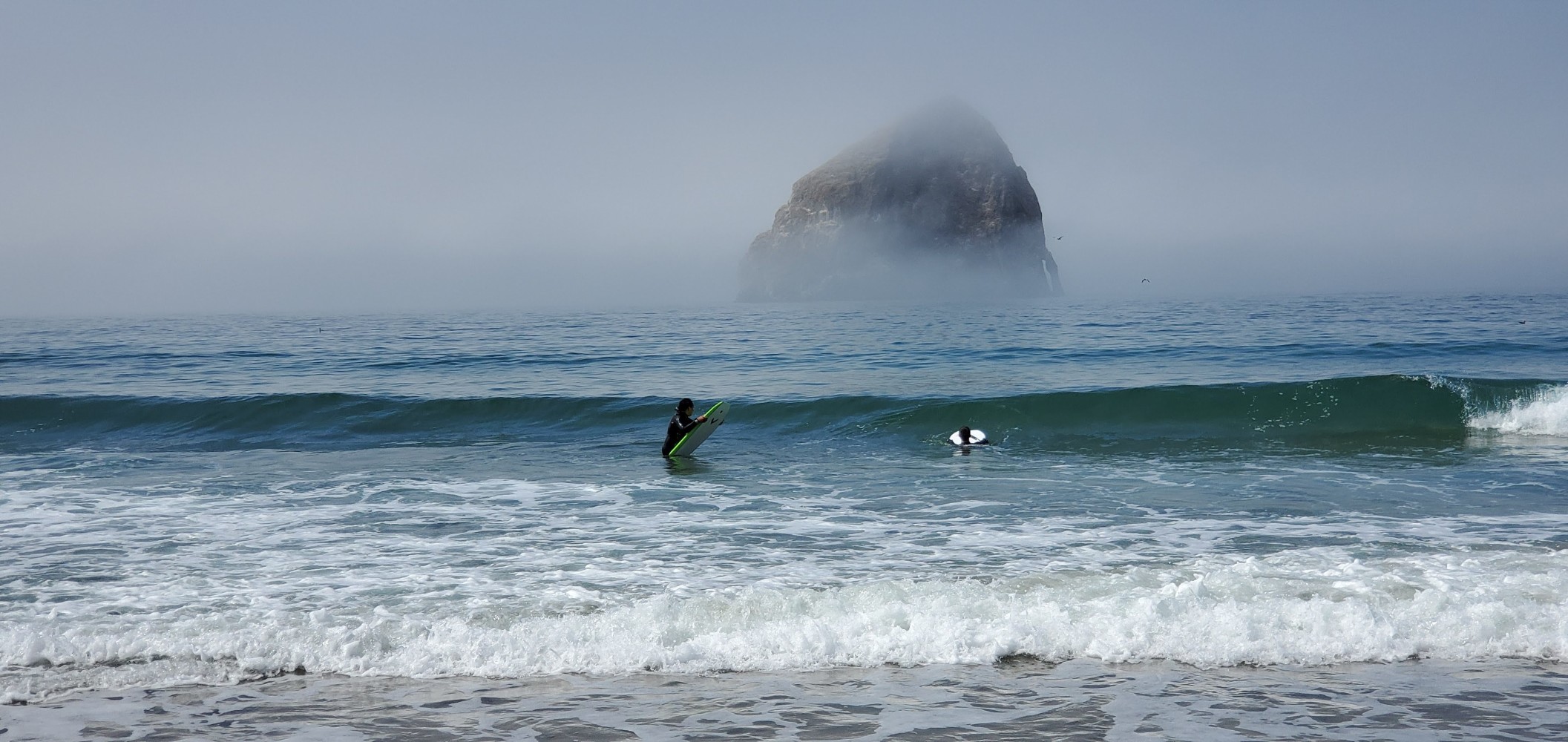 Haystack Rock and surfers at Cape Kiwanda. This was my first view of the Pacific Ocean.