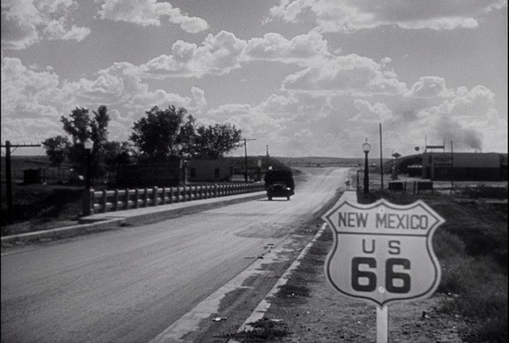 "Highway 66 is the main migrant road. 66 - the long concrete path across the country, waving gently, up and down on the map, from the Mississippi to Bakersfield - over the red lands and the gray lands, twisting up into the mountains, crossing the Divide and down into the bright and terrible desert, and across the desert to the mountains again, and into the rich California valleys."John Steinbeck, "The Grapes of Wrath," Chapter Twelve. (the image is from the 1940 movie)
